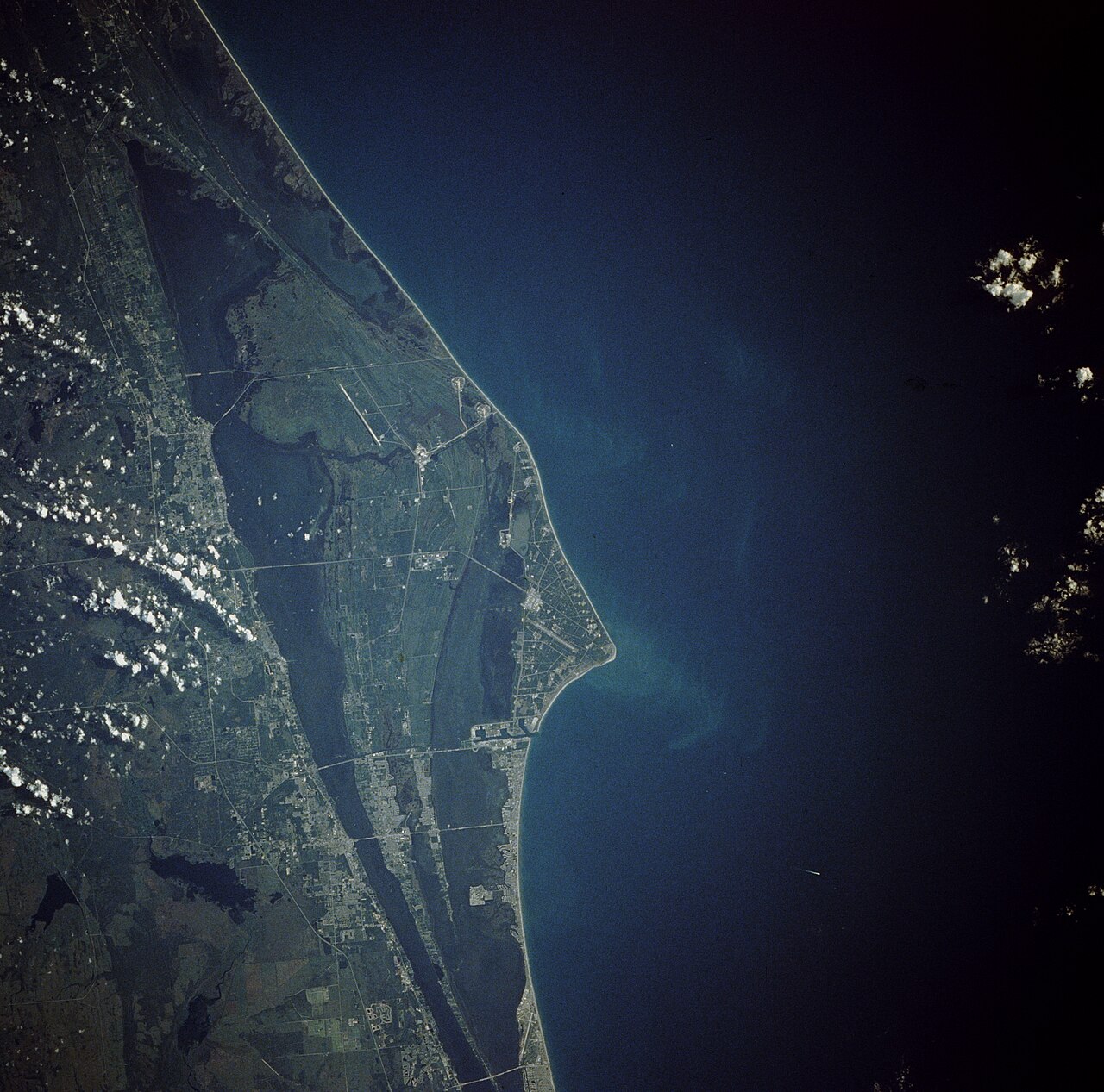 An orbital photograph of Cape Canaveral and Kennedy Space Center showing the Florida coastline and launch-site geography.