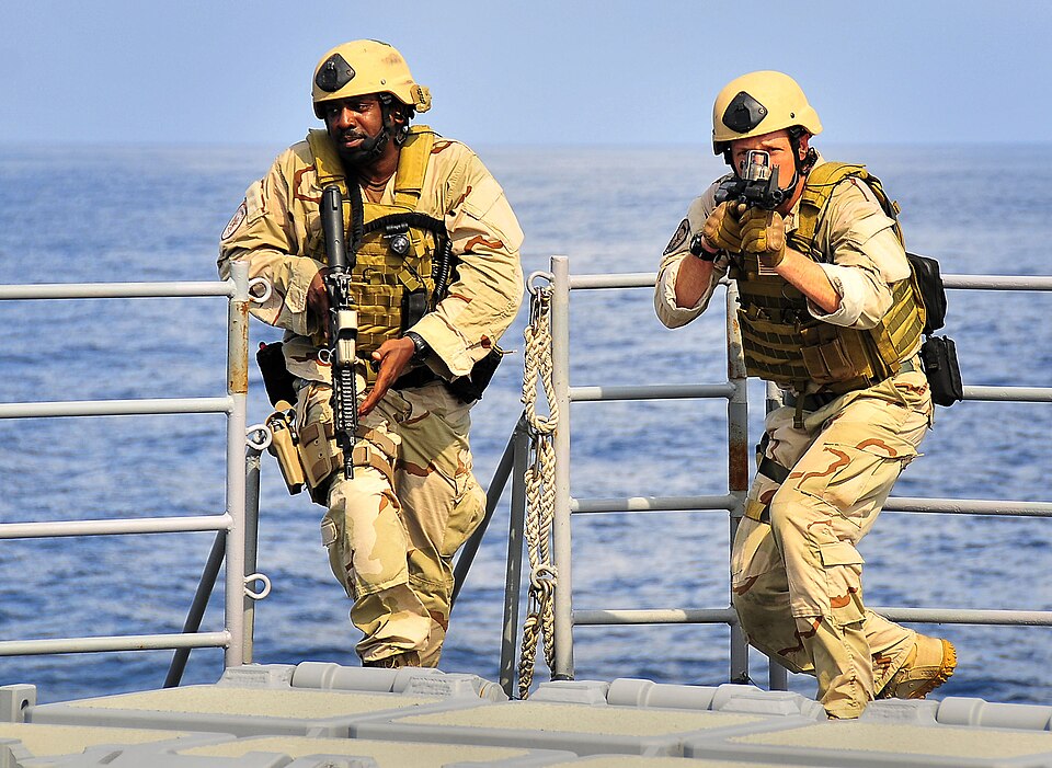 US Navy sailors conduct a tactical training exercise aboard a ship.