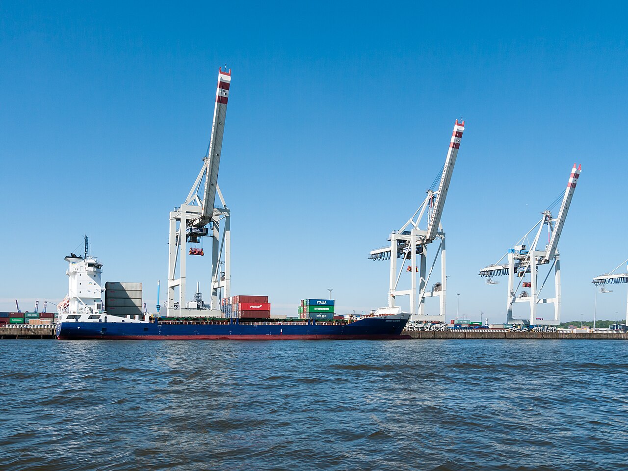 Container cranes and a cargo vessel at Hamburg’s Tollerort terminal