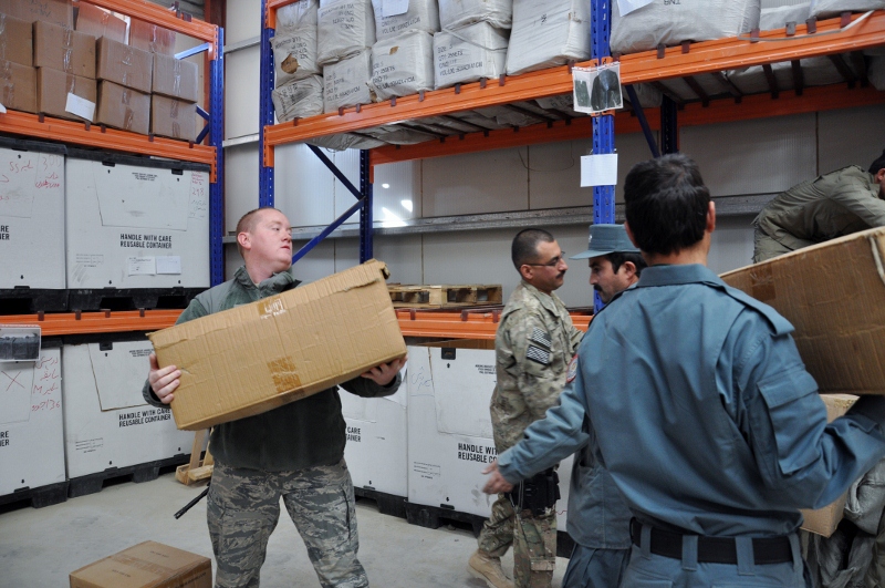 Workers handling cartons in a warehouse